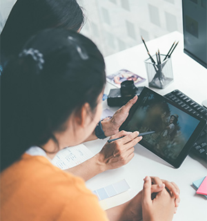 A designer sketching an interface on a graphics tablet