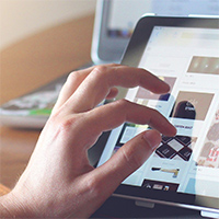 A hand using an app on a tablet screen